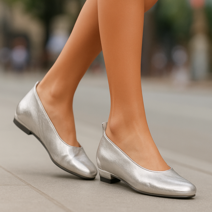 Silver shoes worn by a person on a blurred background